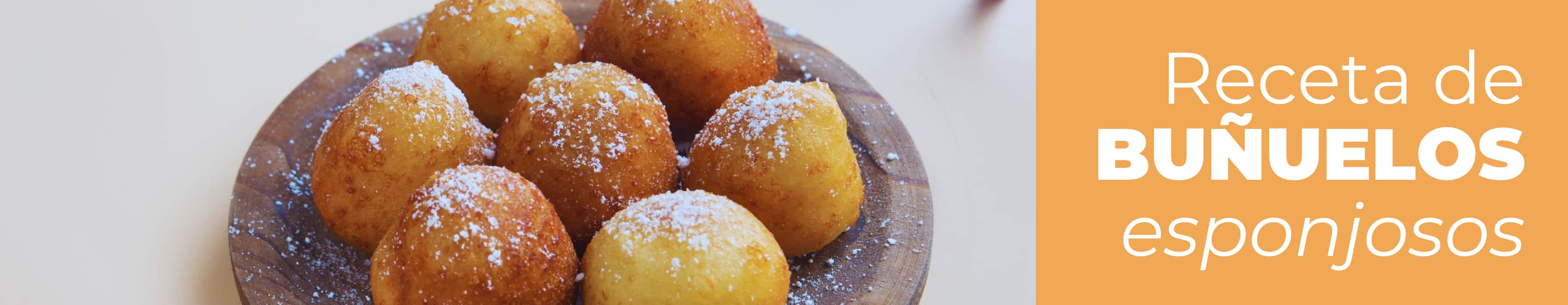 Plato con buñuelos tradicionales dorados y espolvoreados con azúcar y canela listos para servir.